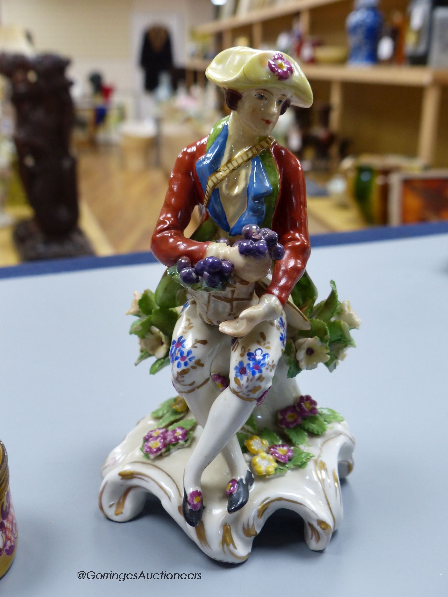 Two Chelsea style porcelain figures, tallest 13cm, and a Meissen style porcelain box